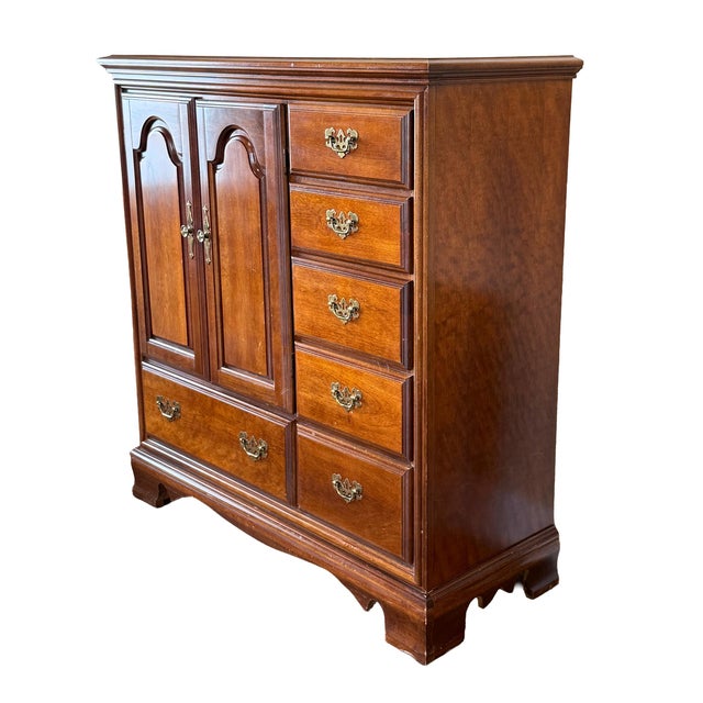 Classic Bassett Furniture dresser/armoire from the 1980s, crafted in rich cherry wood with traditional styling. This...