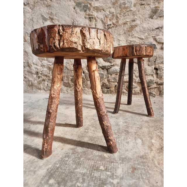 Set of two vintage wooden stools originating from France and dating from approximately the 1960s. The stools feature thick...