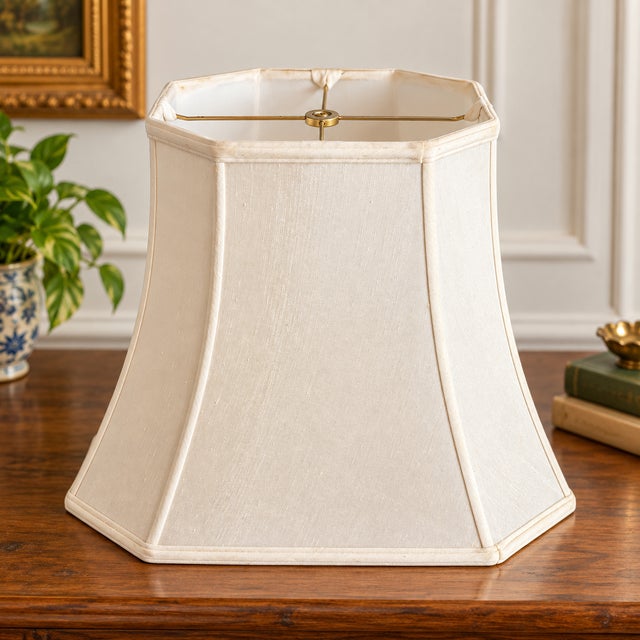 Vintage mid-century lamp shade in a classic octagonal bell silhouette, finished in an ivory-toned textured fabric with...