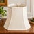 Vintage mid-century lamp shade in a classic octagonal bell silhouette, finished in an ivory-toned textured fabric with...