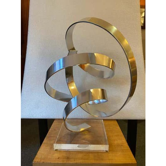 Dan Murphy Aluminum Sculpture. Curly Twisting bands of aluminum form a sculpture that sits on a lucite base. Signature to...