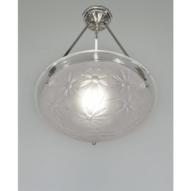 Degué A French art deco pendant light made circa 1930-1935 in nickel plated bronze or solid brass. It holds a bowl by...
