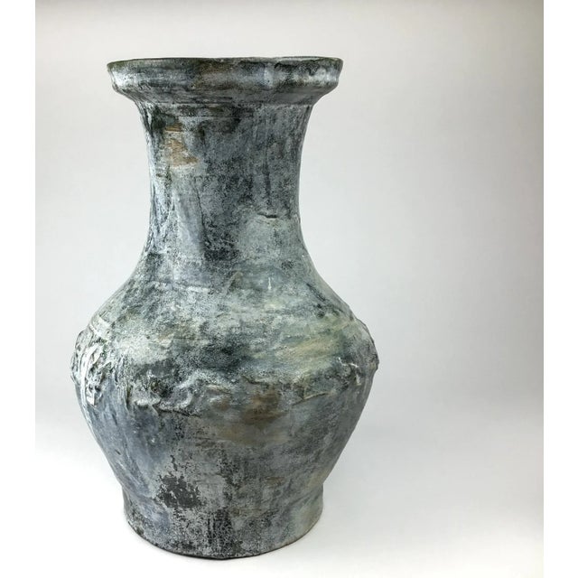 This is an extra-large pear-shaped vessel, shoulder molded with various animals, including a dragon, of which there are 2....