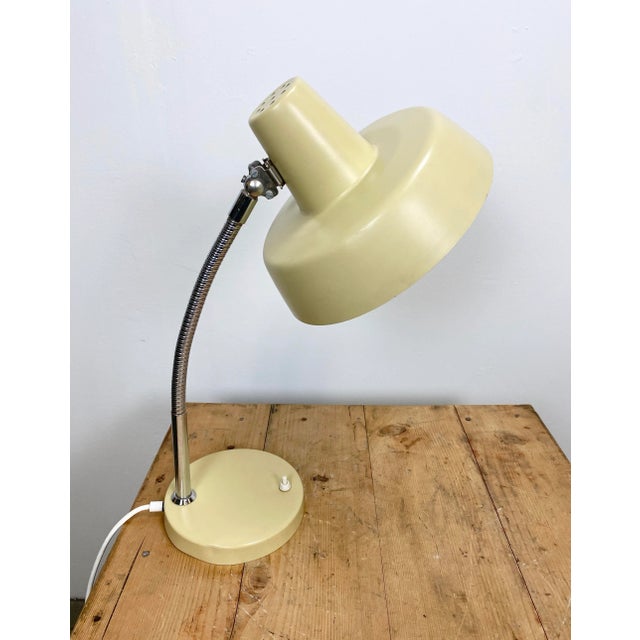 This desk lamp from the 1960s was designed and manufactured in former Czechoslovakia. It features a chrome-plated flexible...