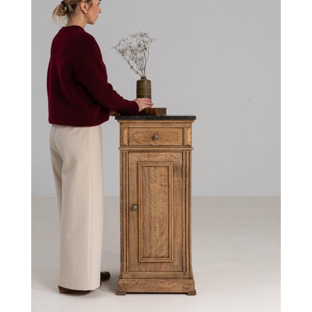 This side cabinet makes its impression through natural oak, single door, dark top. Dating to 19th Century and originating...