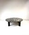 1950's marble top coffee table made by John Widdicomb. Round black marble top has white and hints of pink through out....