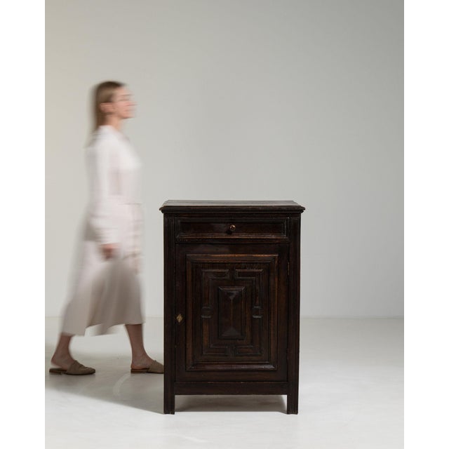 A side cabinet whose black ebonized wood, single drawer, open door gives it real character at first glance. It was made in...