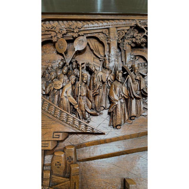 Mid-20th century hand-carved solid teak coffee table purchased in Thailand, featuring a deeply sculpted high-relief...