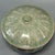 This Chinese Longquan celadon lidded bowl features carved lotus petal patterns on both the bowl body and lid. The glaze...
