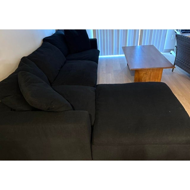 The World of RH Cloud Couch is in like-new condition after just six months of use. The black fabric L-shaped sectional...