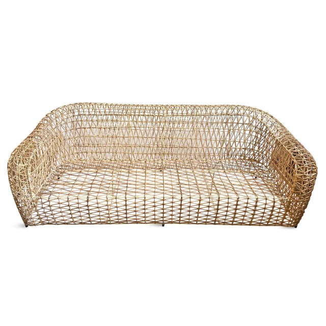 Hand crafted open weave vintage rattan sofa. If exposed to outdoor elements, color of rattan will change over time....