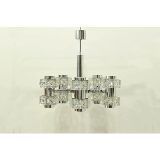 Ceiling lamp of five double lights arranged in circular scheme. The arms have square pieces of glass carved glass. Up to...