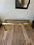 Striking vintage 1970s console table featuring a sculptural brass-tone metal frame, believed to be anodized aluminum,...