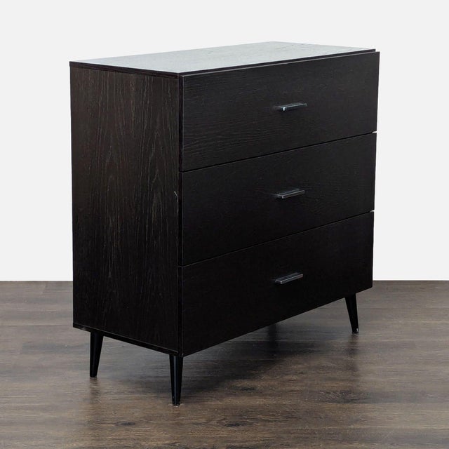 This West Elm dresser features a sleek dark espresso wood finish and three spacious drawers with simple metal handles. The...