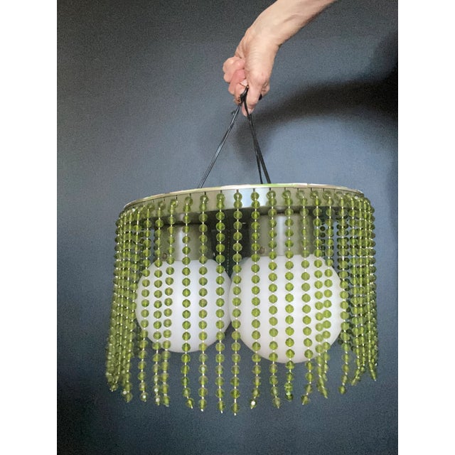 Rare 1970’s avocado and moss green mod style beaded tri globe light chandelier. Metal top with large opaque white glass...