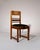 A set of four Amsterdam School dining chairs, Netherlands, 1920s. Crafted in solid oak with subtle coromandel details,...