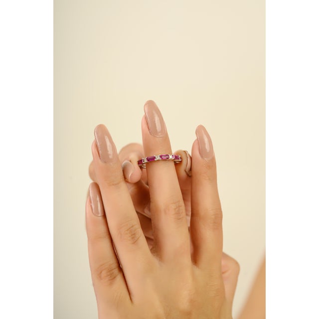 This elegant half-eternity ring features 5 baguette cut rubies totaling 0.87 carats, set in rich 14k white gold. Each ruby...