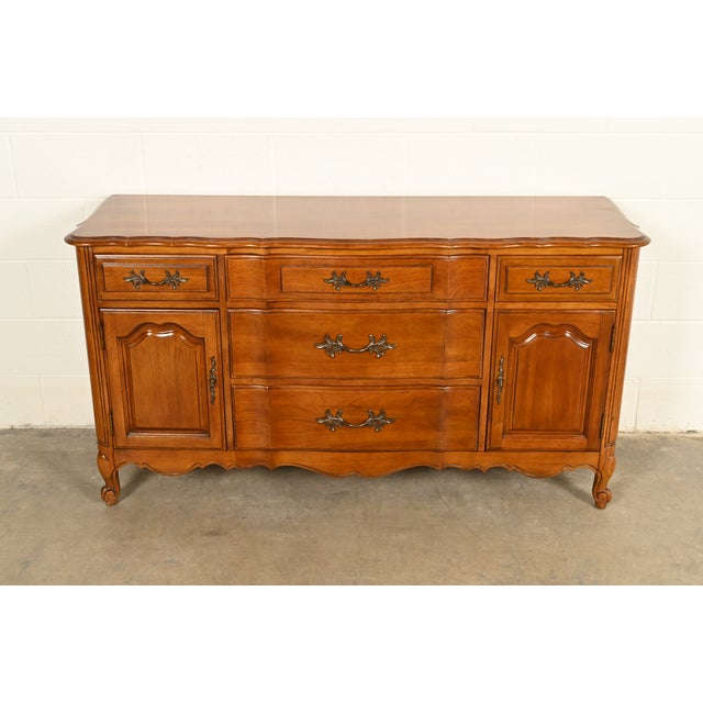An outstanding French Provincial Louis XV style sideboard buffet, credenza, or bar cabinet By Thomasville USA, Circa 1970s...