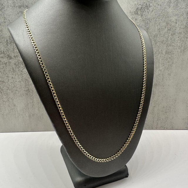 This classic 14kt yellow gold curb chain features a timeless, polished design that’s perfect for everyday wear. Measuring...
