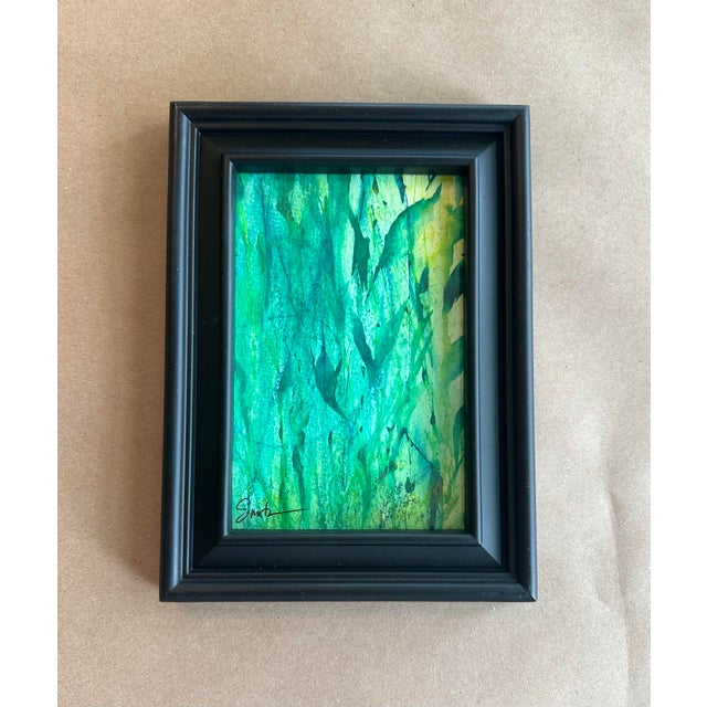 A soothing abstract watercolor awash in layered emerald, teal, and sea-glass hues. Gentle vertical movement and...