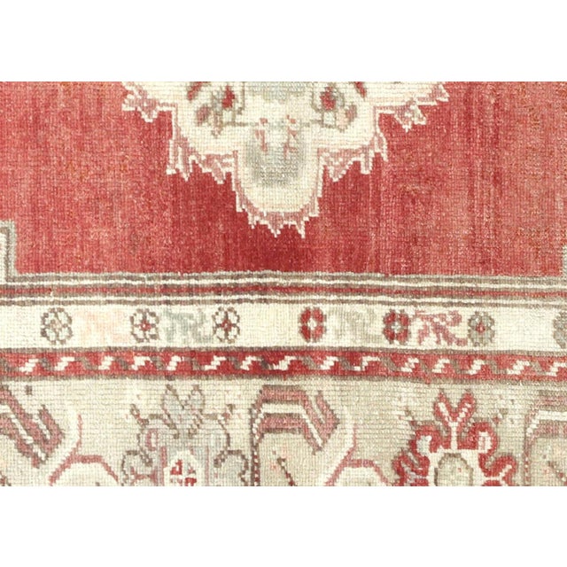 Handwoven wool-on-wool Oushak rug from vintage Turkey, measuring 3'2" x 5'1". Originating from the storied weaving...