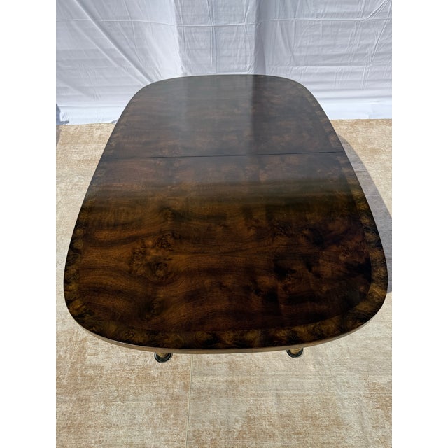 This luxurious burlwood and brass dining set is an exceptional example of high-end American design. While unmarked, the...