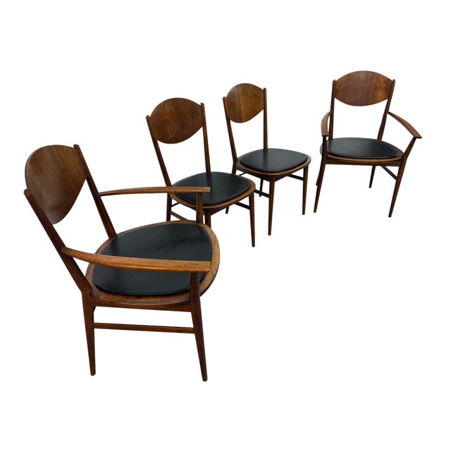Offered here is a stunning set of four Mid-Century Modern walnut dining chairs from the highly sought-after Delineator...