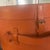 A leather containers with a single working strap, beautifully lined in a deep red fabric. Old world style. 17 inches wide...