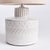 A ceramic base, this little lamp has a speckled, reactive glaze that plays off the carved graphic pattern. Topped with a...