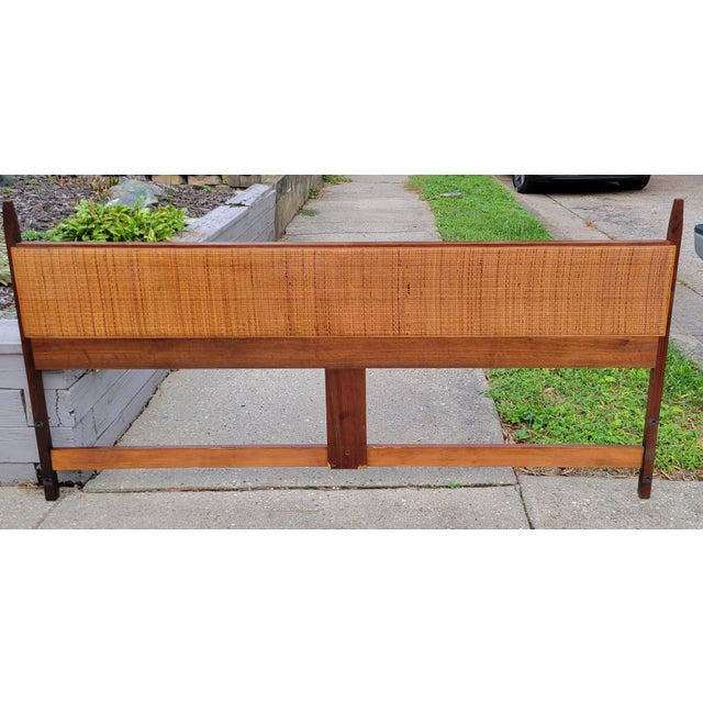 Walnut king headboard in the style of Jack Cartwright with full length hand woven cane inlay. Dimensions: 78 in wide x 1...