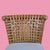 A pair of McGuire-style counter stools with signature leather strap detailing, blending rattan craftsmanship with rugged...
