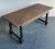 This imposing vintage table embodies the rugged charm of primitive and farmhouse aesthetics, likely inspired by...