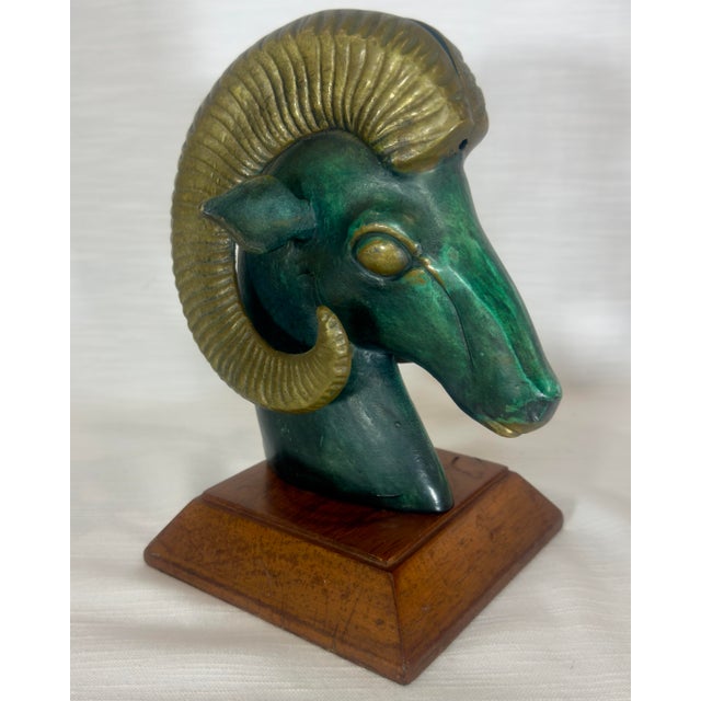 Discover the allure of this vintage Mid-Century Modern patinated brass ram head sculpture, a stunning piece that embodies...