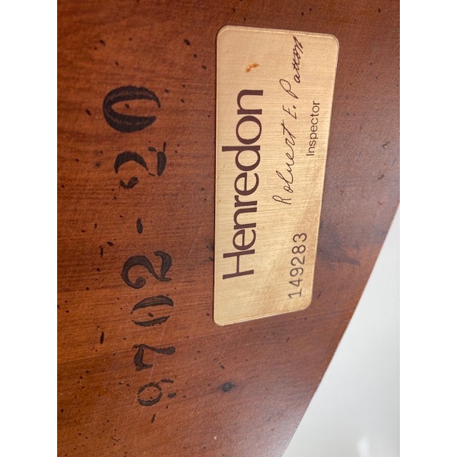 An exceptionally beautiful round dining table has classic lines and a richly banded top, signed by famous maker,...