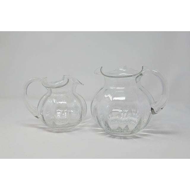 This is a gorgeous pair of handblown Crystal Devon Pitchers by Tiffany & Co. The larger has a capacity of roughly 54 oz...