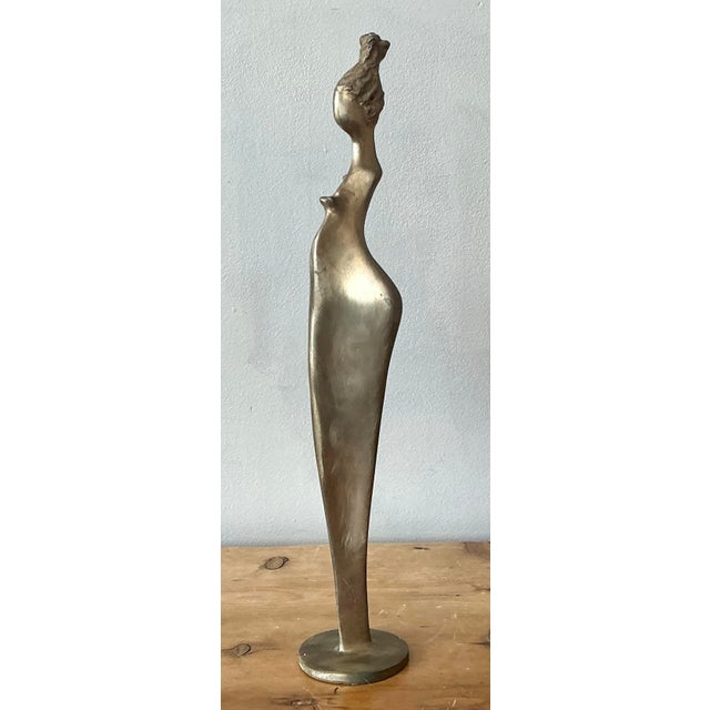 This stunning vintage brass sculpture presents a compelling abstract interpretation of the female form, defined by an...