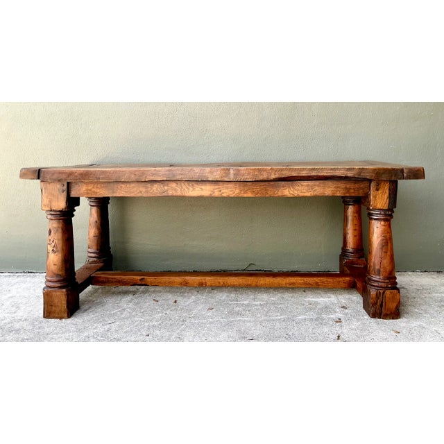 Crafted with monumental proportions and artisan joinery, this vintage Belgian trestle dining table is built from thick,...