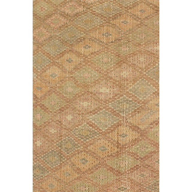 This flat-woven Embroidered Kilim rug is characterized by its repeating pattern of diamonds, rendered in earth-tones with...