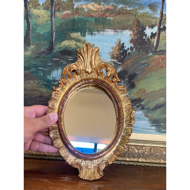 A vintage Florentia possibly giltwood wall mirror, hand made in Italy and labeled on the reverse. This small oval mirror...