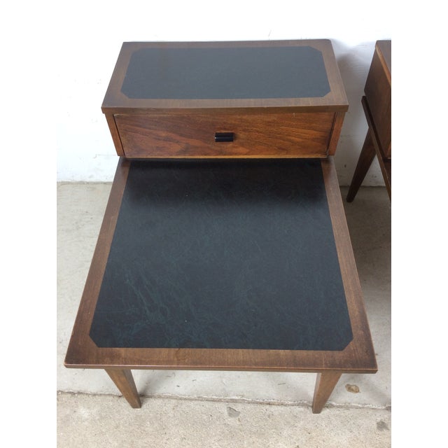 This pair of mid century modern end tables by Kroehler features hardwood construction, original walnut finish, step...