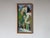 A vibrant vintage Impressionist oil on canvas depicting a charming European street scene with colorful, lush greenery, and...
