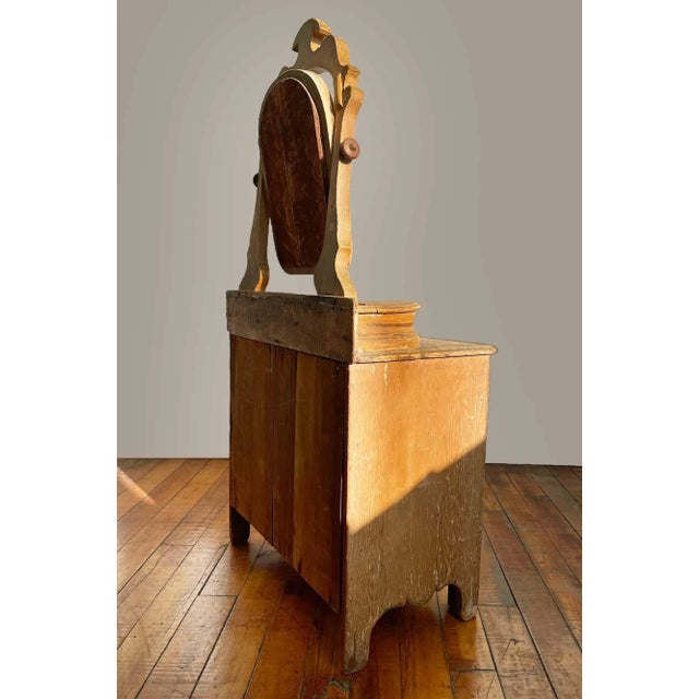 Antique child's chest of drawers. Three large drawers and two compartments at base of the swivel mirror. This is a...