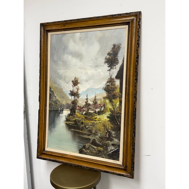 Design Plus Gallery presents a Vintage Signed European Lakeside Village Oil Painting. This original oil on canvas depicts...