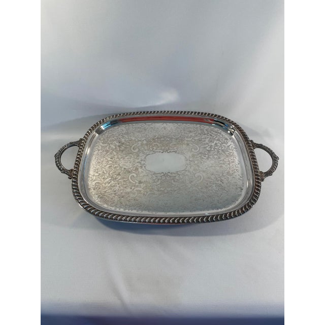 An elegant Silverplated Oblong Platter or Tray with ornate handles and claw feet. Circa 1970s. Made by the well known...