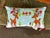 Christmas pillow with reindeers. Measures 12” x 21”. Has red bells on the corners. Great item for Christmas decor.