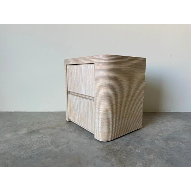 A beautiful Vintage pencil reed rattan nightstand. Gorgeous design and texture. Features two drawer, and finished in a...