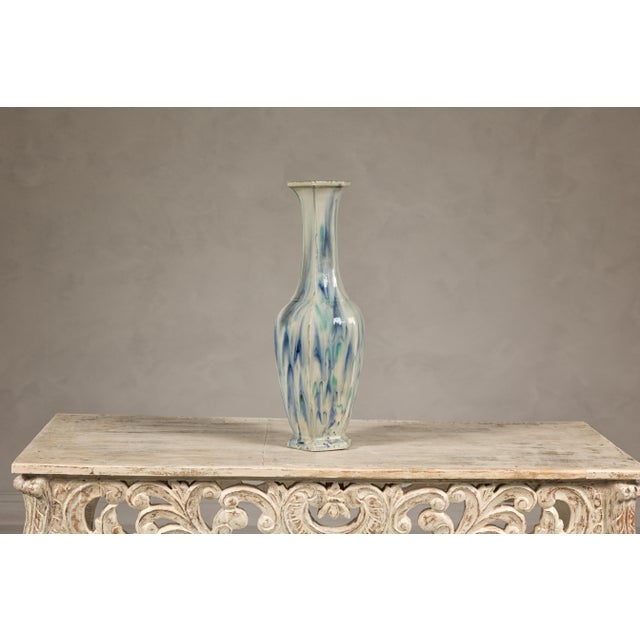 This vintage multi-color drip vase captivates with its unique design and subtle palette, blending a cream ground with...