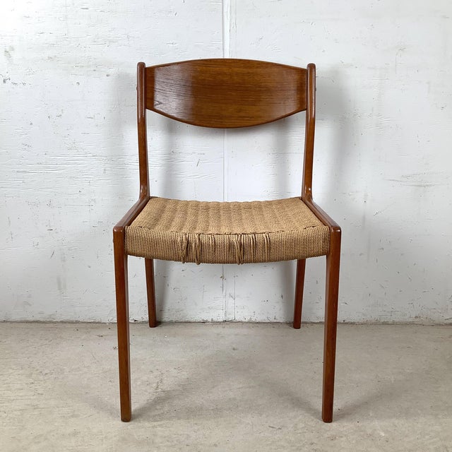 If you know Danish furniture, you know exactly what this chair is the moment you see it. The curved teak back splat. The...
