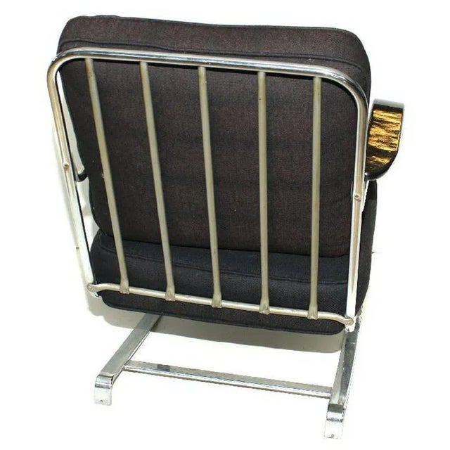 Known as the “Springer” chair, the chairs sit on chromed flat iron springs and function as rocking chairs. The chair...