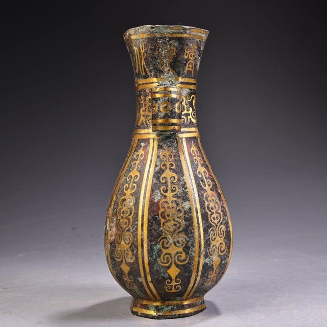 Beautiful archaic-style bronze hu vase with distinctive tubular arrow ears on both sides. The vessel is decorated with...